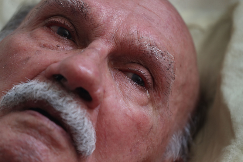Elmer Vasquez Colon, 80, sheds tears due to pain after not having medication for one month since two hurricanes passed through the area as he lays in his bed at the Pedro America Pagan de Colon assisted living facility in the aftermath of Hurricane Maria on October 1, 2017 in San Juan, Puerto Rico. Members of the First Medical Relief team visited the complex and said the residents need water and many are hungry and have not been able to get all their medication. (Photo by Joe Raedle/Getty Images)